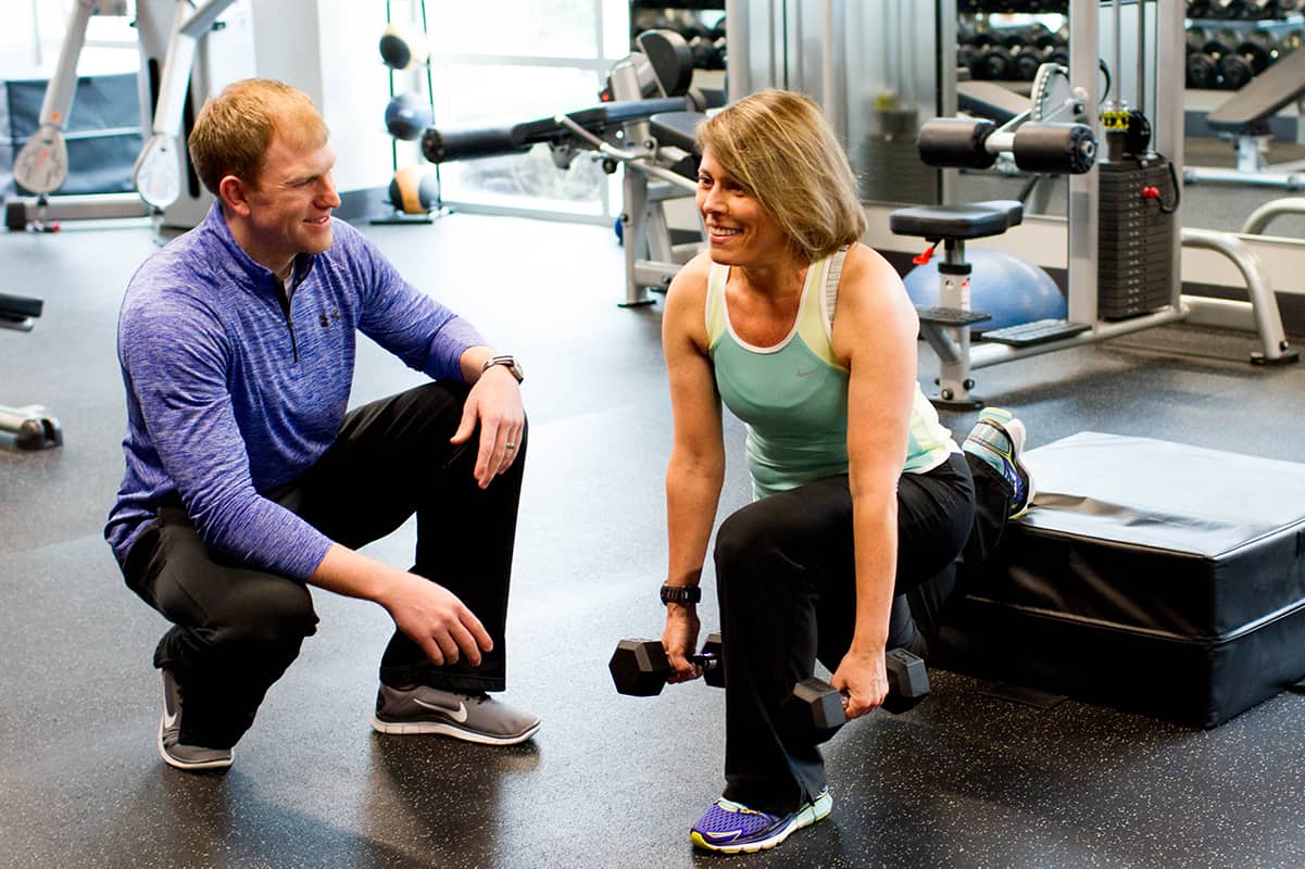 A personal trainer working with a client